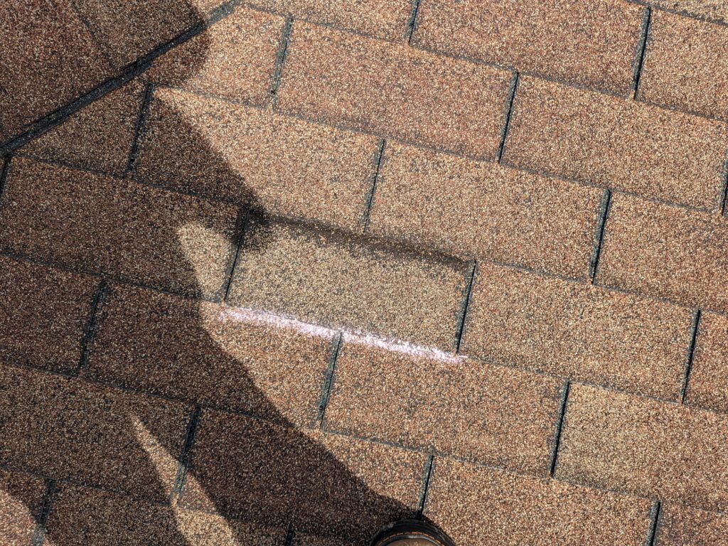 Shingle granule loss along crease line